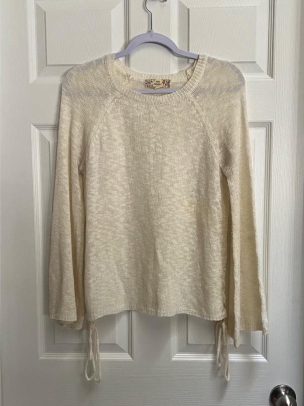 Cream knit sweater with braid details on the sides